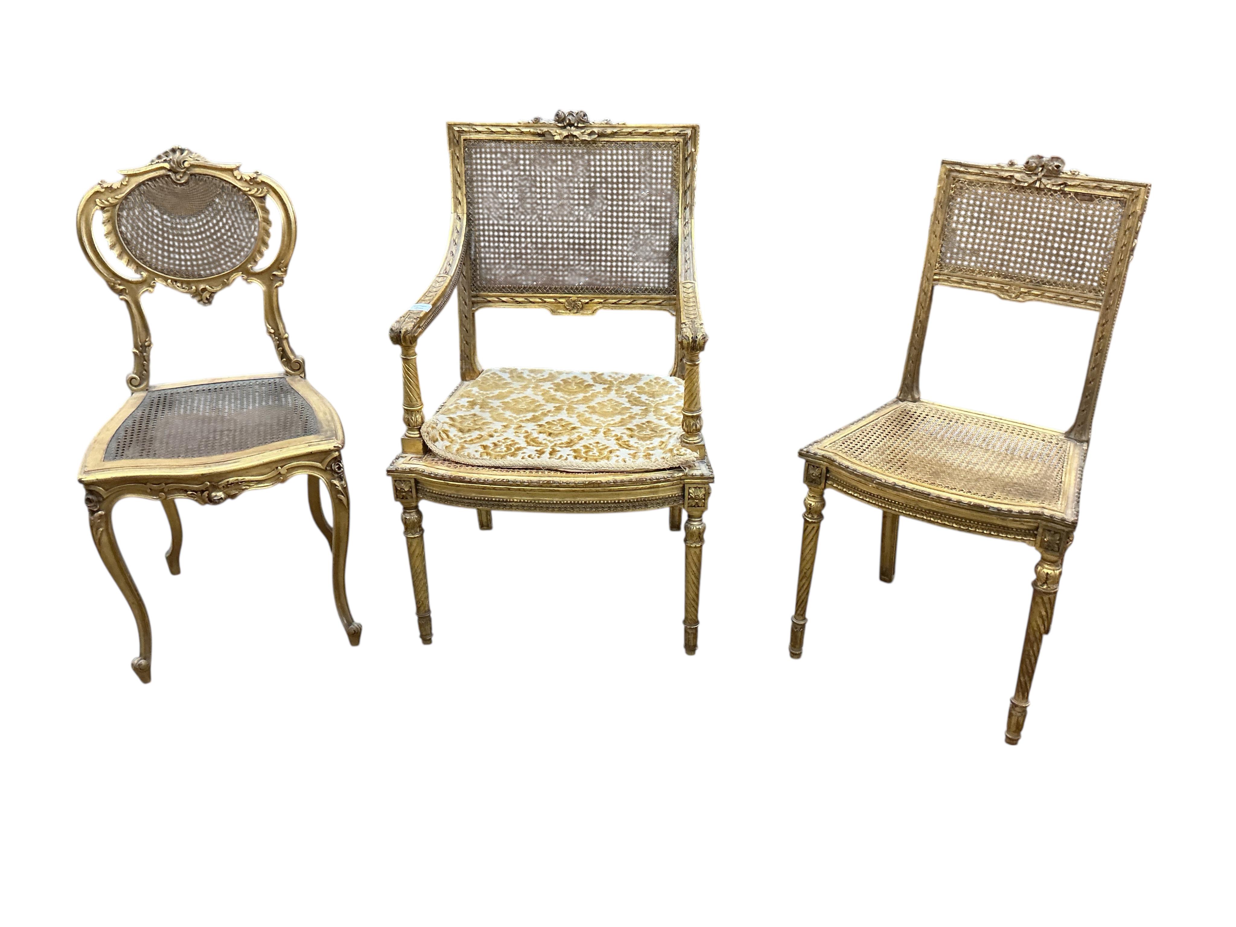 A late 19th century French Louis XVI style open elbow chair with cane seat, a matching side chair and another giltwood side chair